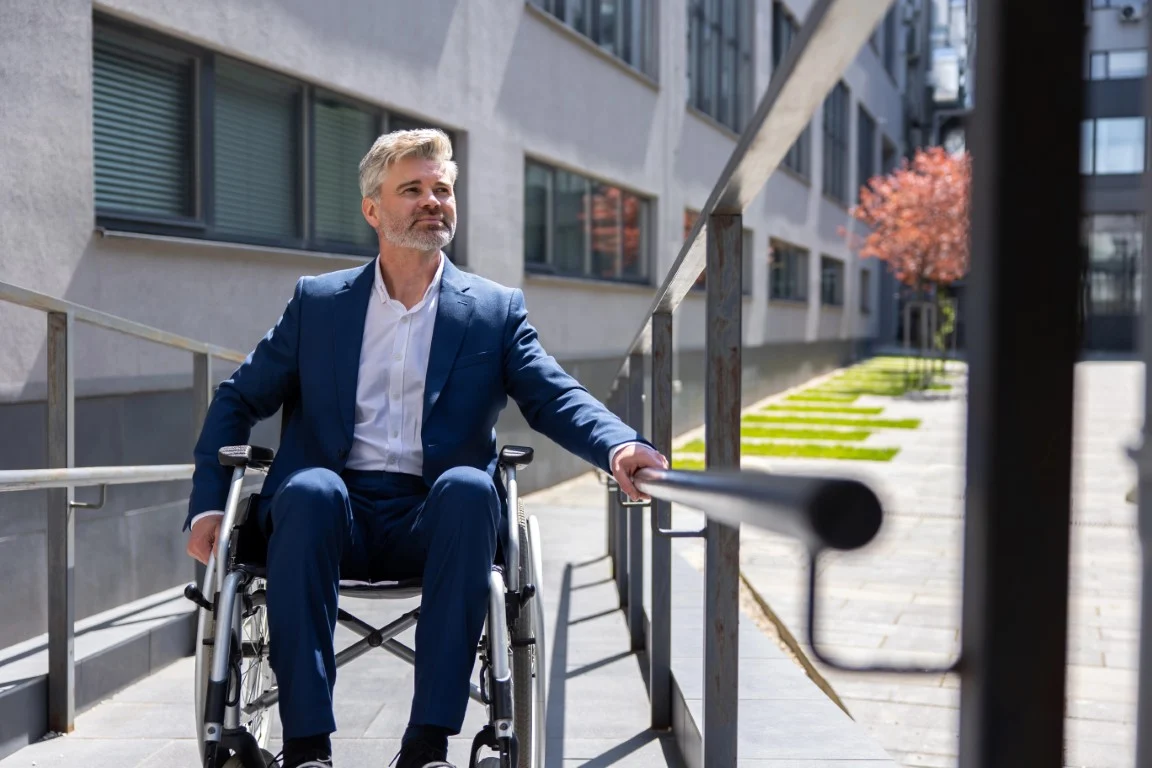 What Happens If a Business Isn’t ADA-Compliant? man in wheelchair going up ramp